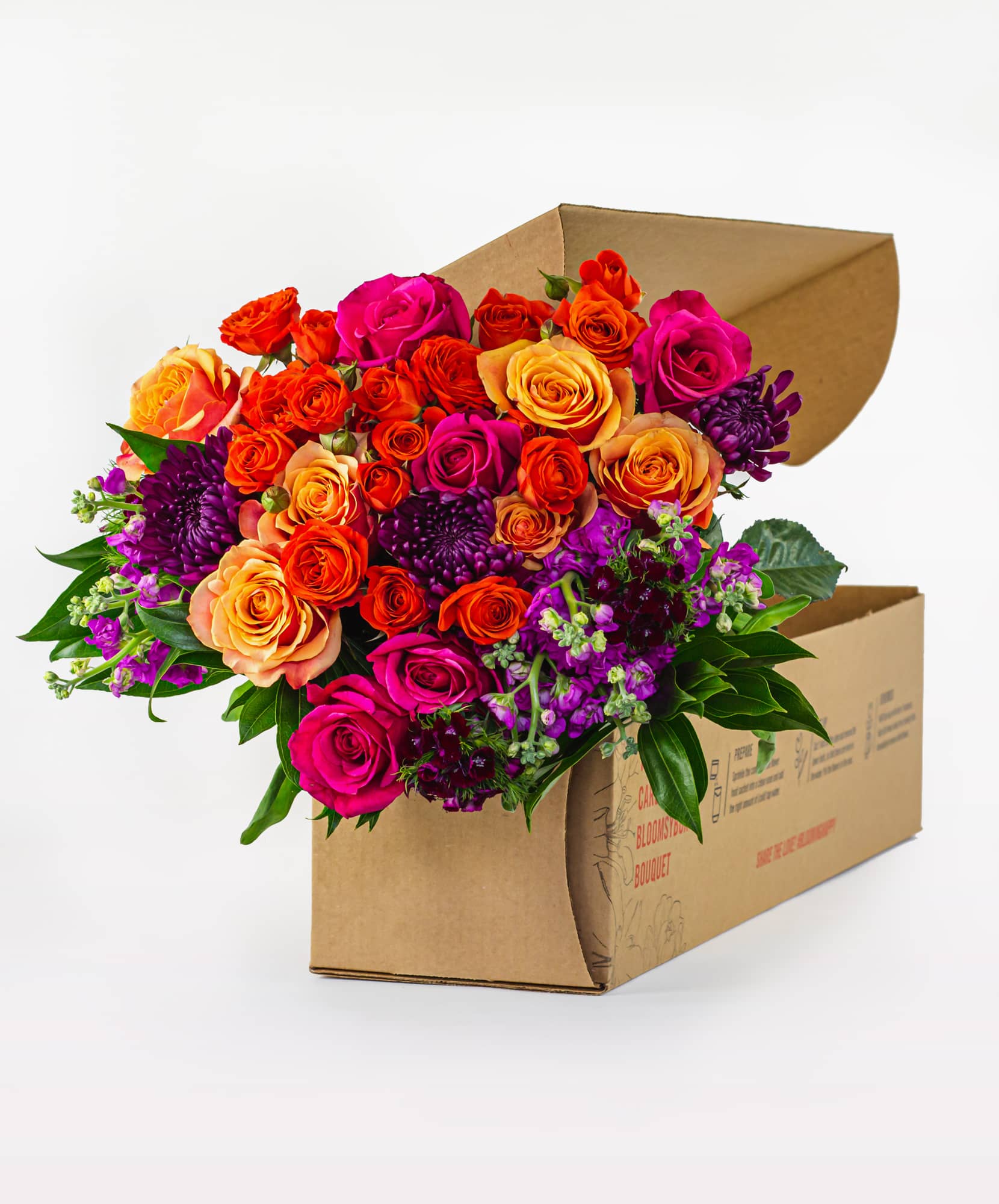 Vibrant floral bouquet with mixed roses and blooms in a chic delivery box.